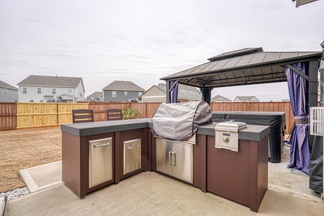 view of patio featuring a gazebo, area for grilling, and grilling area