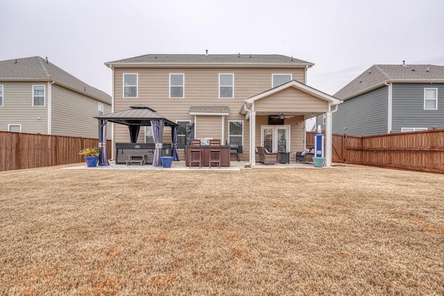 back of house with a lawn, ceiling fan, a gazebo, a patio area, and an outdoor hangout area