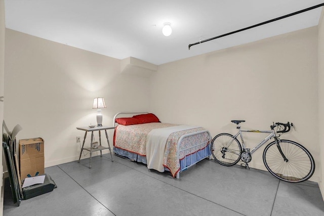 bedroom featuring concrete floors