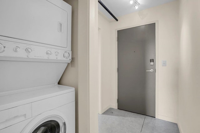 clothes washing area with stacked washer and clothes dryer