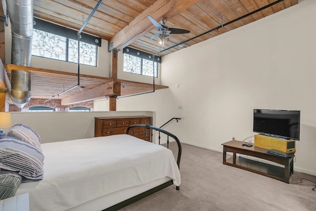 bedroom featuring beamed ceiling, wooden ceiling, ceiling fan, and carpet