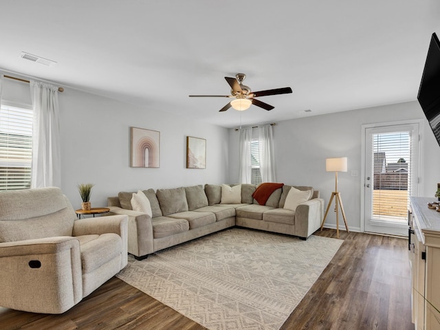 living room with wood-type flooring, ceiling fan, and plenty of natural light