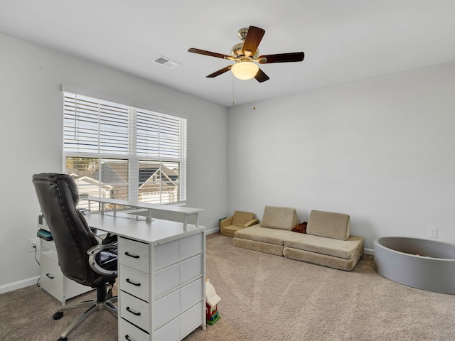 carpeted office space with ceiling fan