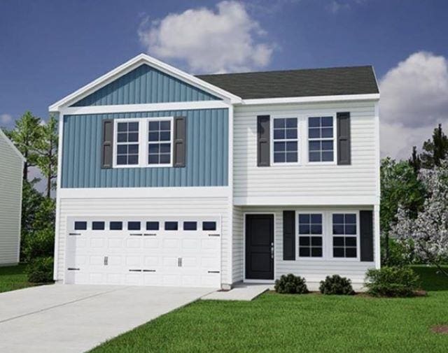 view of front facade with a garage and a front lawn