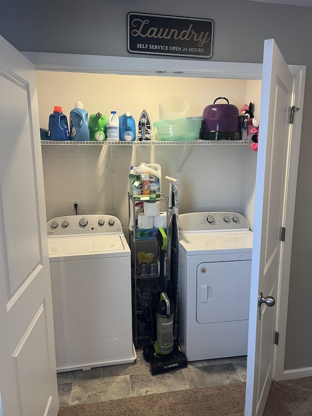 clothes washing area with washer and clothes dryer