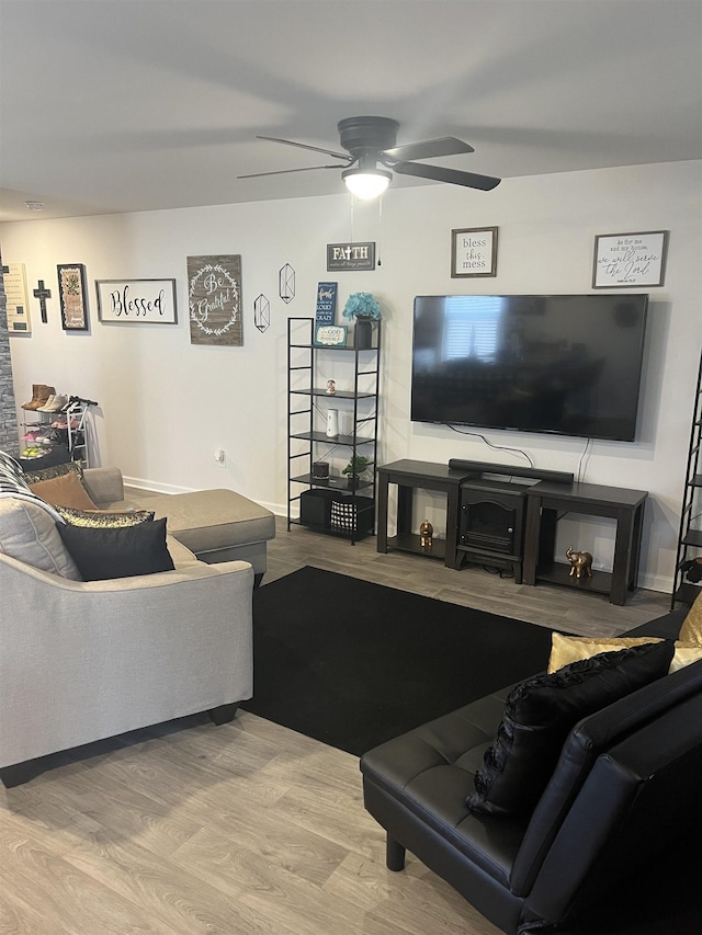 living room featuring hardwood / wood-style flooring and ceiling fan