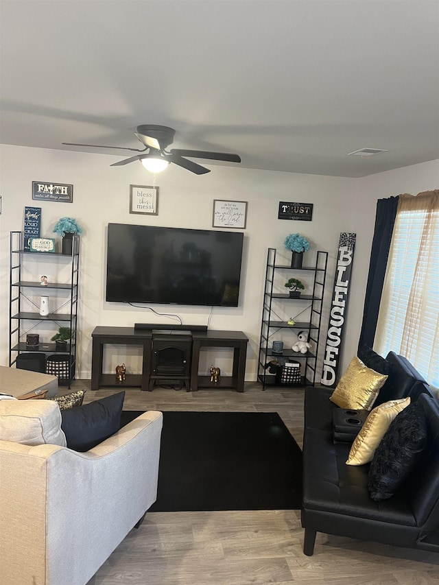 living room featuring hardwood / wood-style floors and ceiling fan