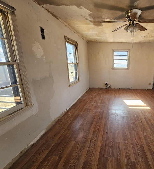 empty room with dark hardwood / wood-style floors and ceiling fan