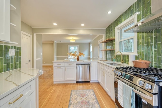 kitchen with sink, crown molding, light hardwood / wood-style flooring, appliances with stainless steel finishes, and white cabinets