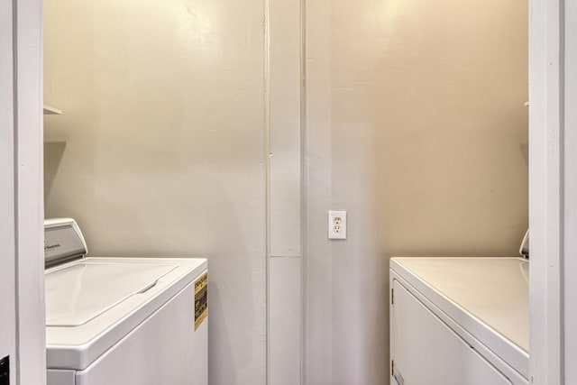 washroom with washing machine and clothes dryer