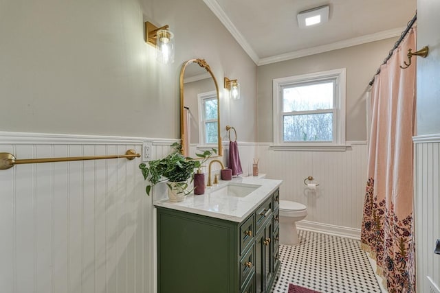 bathroom with ornamental molding, vanity, and toilet