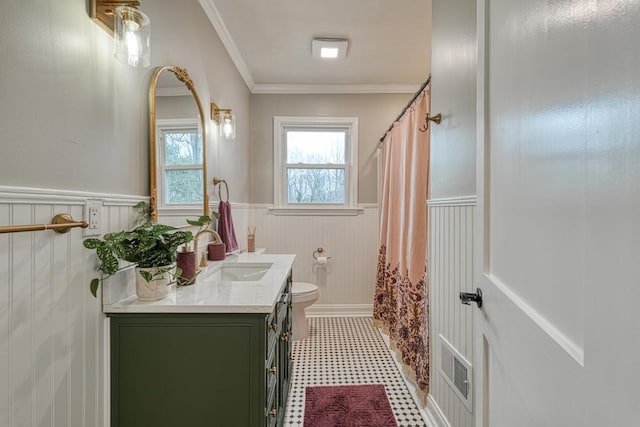 bathroom featuring ornamental molding, vanity, and toilet