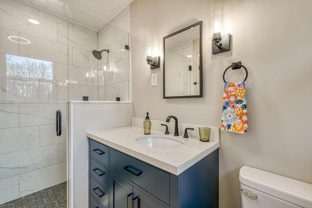 bathroom with an enclosed shower, vanity, and toilet