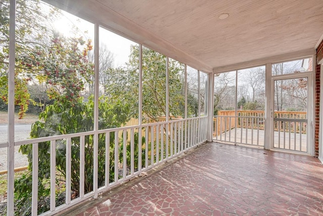 unfurnished sunroom featuring wooden ceiling