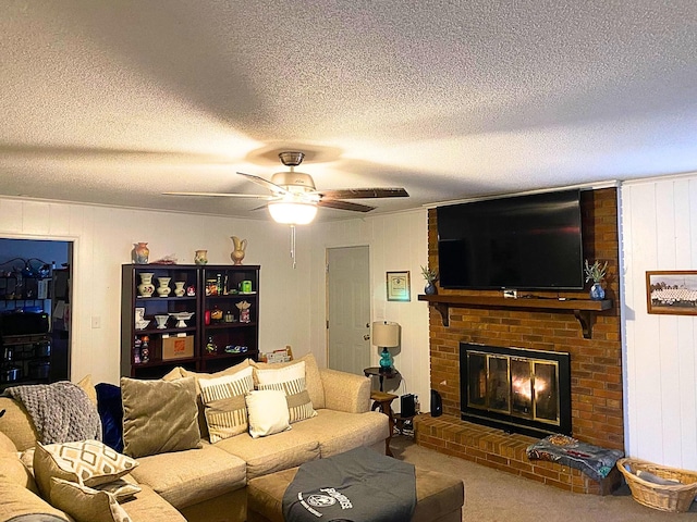 carpeted living room featuring wooden walls, ceiling fan, a brick fireplace, and a textured ceiling