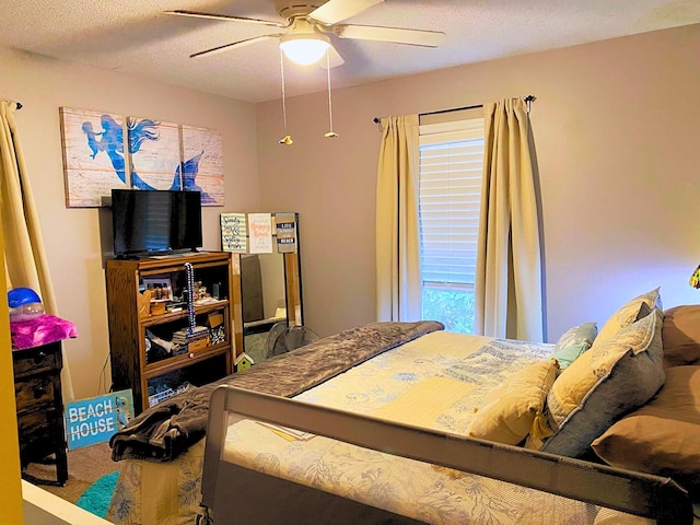 bedroom with a textured ceiling and ceiling fan