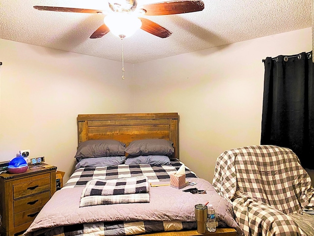 bedroom with a textured ceiling and ceiling fan