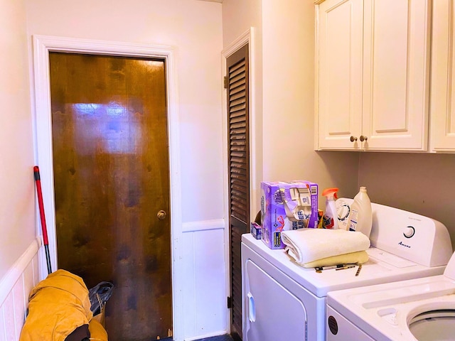 washroom featuring cabinets and washing machine and clothes dryer