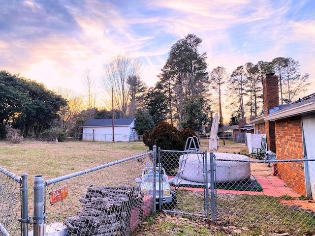 view of yard at dusk