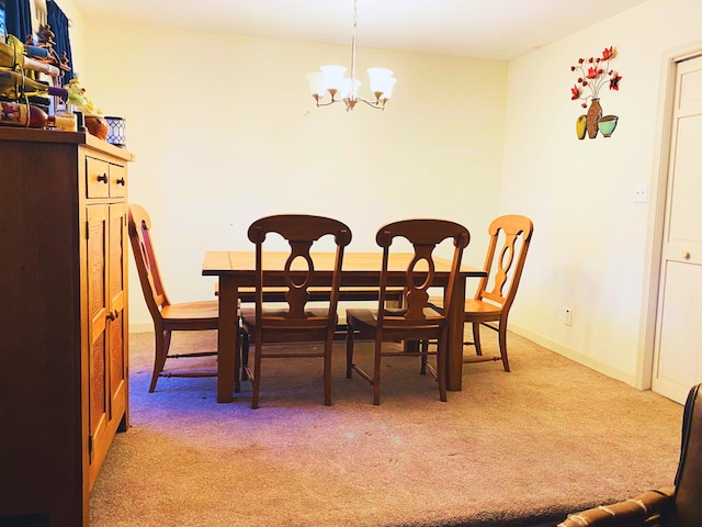 dining room featuring a chandelier and carpet