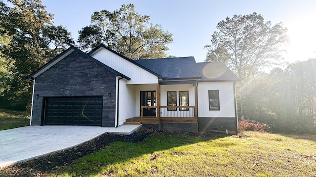 modern farmhouse style home with a porch, a garage, and a front yard