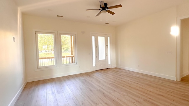 empty room featuring ceiling fan and light hardwood / wood-style floors