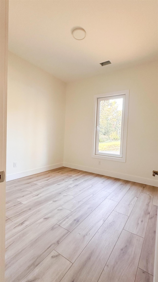 spare room featuring light hardwood / wood-style floors