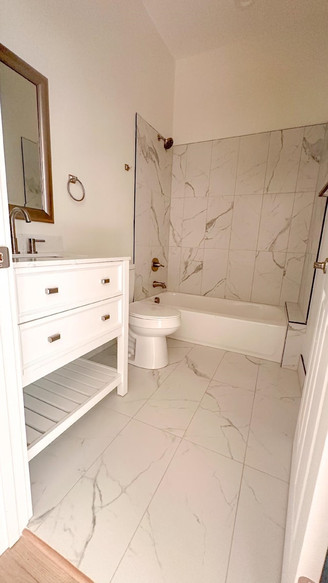 full bathroom featuring vanity, tiled shower / bath combo, and toilet