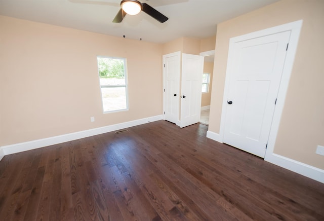 unfurnished bedroom with dark hardwood / wood-style floors and ceiling fan