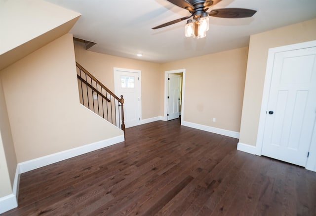 unfurnished living room featuring ceiling fan and dark hardwood / wood-style floors