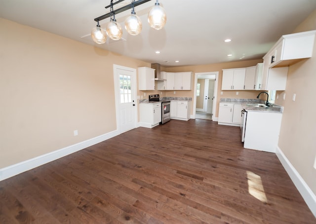 kitchen with stainless steel range with electric stovetop, white cabinets, dark hardwood / wood-style flooring, decorative light fixtures, and wall chimney exhaust hood