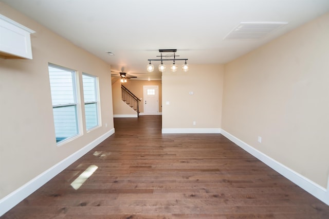 interior space with dark hardwood / wood-style floors and ceiling fan