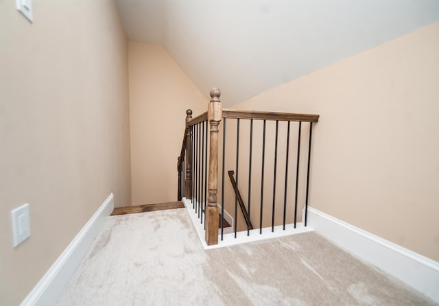 stairs with carpet floors and vaulted ceiling