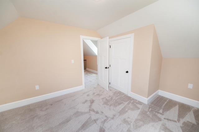 additional living space with vaulted ceiling and light colored carpet