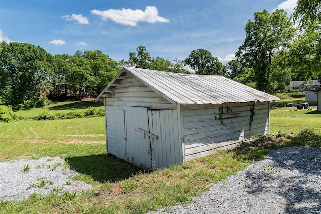 view of outbuilding with a lawn