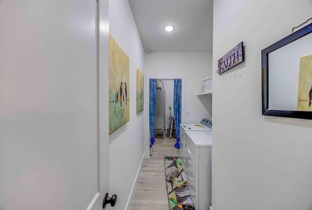 corridor with washing machine and dryer and light hardwood / wood-style floors