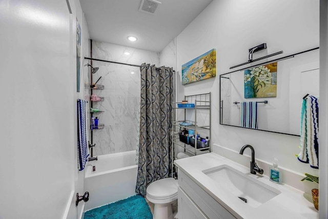 full bathroom with vanity, shower / bath combo, and toilet