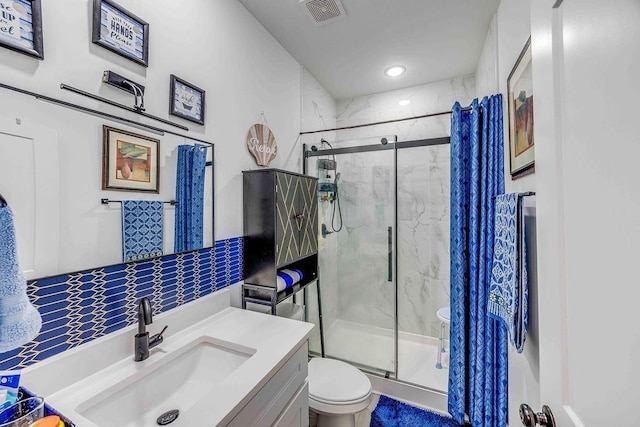 bathroom featuring vanity, toilet, and an enclosed shower