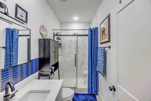 bathroom featuring vanity, toilet, and walk in shower