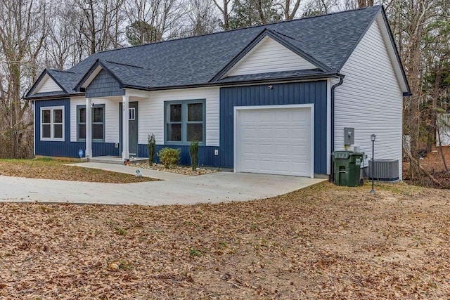 single story home with cooling unit and a garage