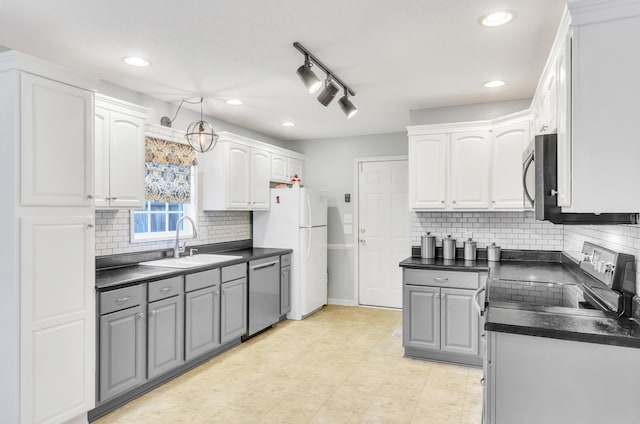 kitchen featuring gray cabinets, appliances with stainless steel finishes, sink, and white cabinets