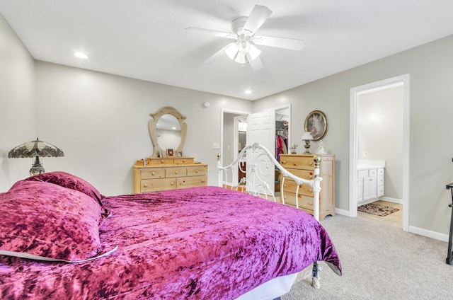 bedroom with ensuite bath, carpet floors, and ceiling fan