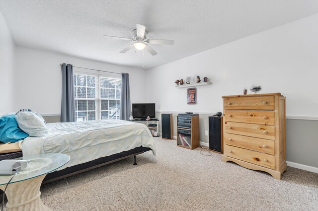 carpeted bedroom with a textured ceiling and ceiling fan