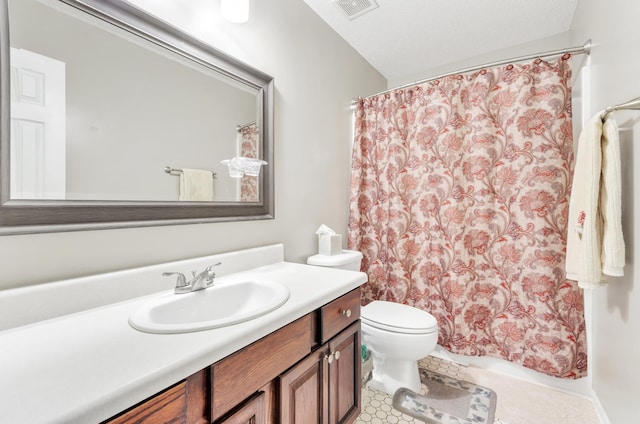 bathroom with vanity, a textured ceiling, and toilet