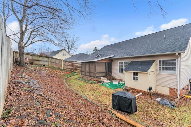 rear view of property with a sunroom