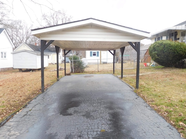 view of vehicle parking with a carport and a lawn