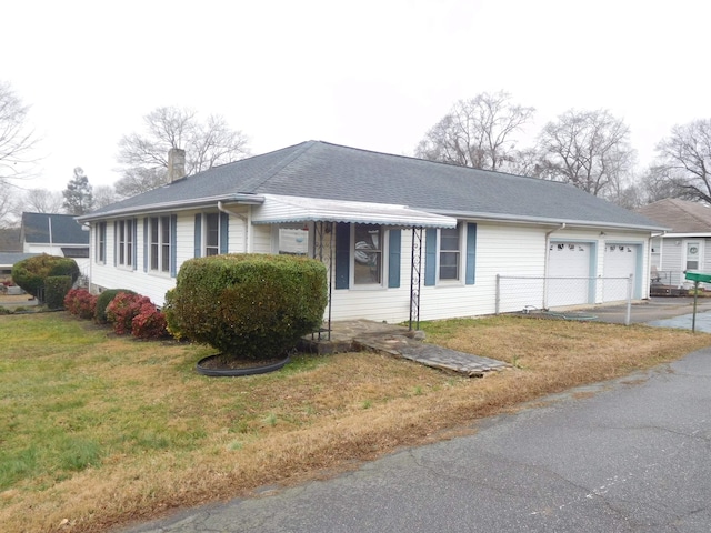 view of home's exterior featuring a garage and a yard