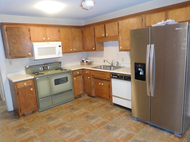 kitchen featuring sink and white appliances