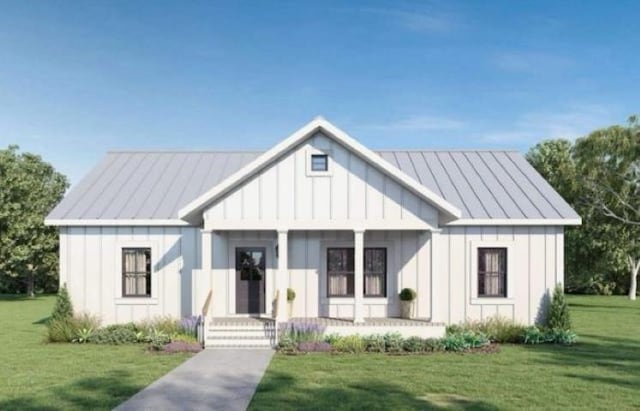 modern farmhouse style home featuring a standing seam roof, a front yard, board and batten siding, and metal roof