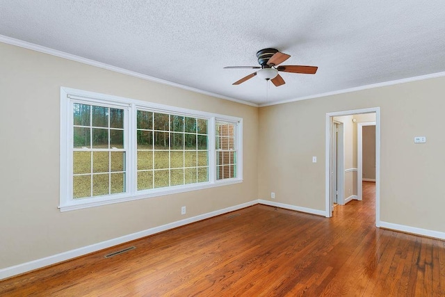 unfurnished room with wood-type flooring, ornamental molding, a textured ceiling, and ceiling fan